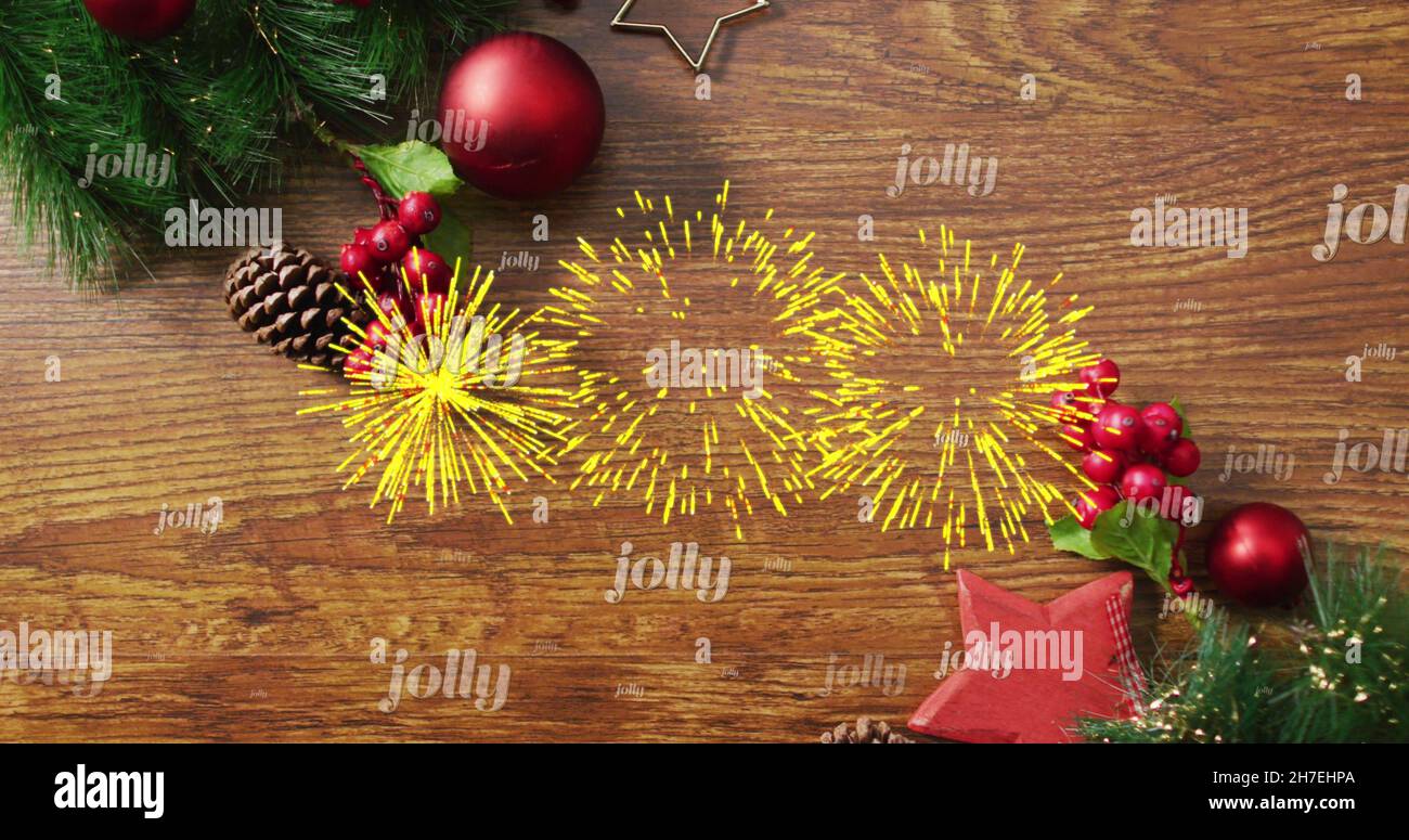 Immagine di testo jolly in ripetizione e fuochi d'artificio su decorazioni natalizie Foto Stock