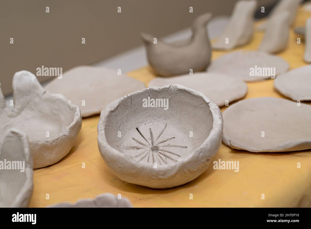 souvenir e gioielli in ceramica nel processo di produzione artigianale. Dipinte a mano e applicate Foto Stock