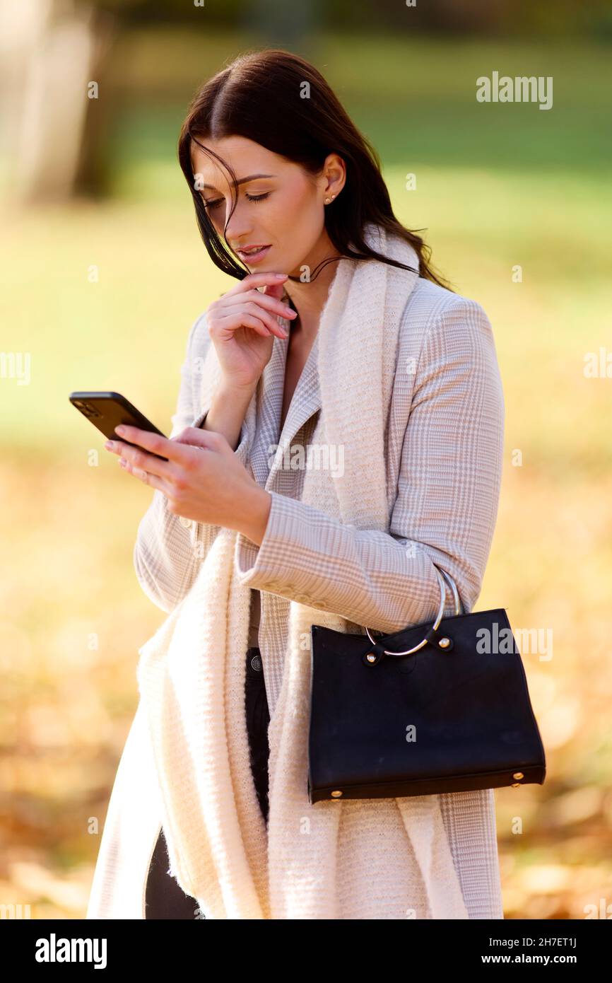 Donna preoccupata guardando il suo telefono Foto Stock