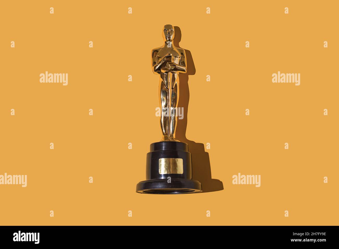 Oscar premia il trofeo su sfondo giallo. Premio, industria cinematografica, Hollywood e concetto vincitore. Foto Stock