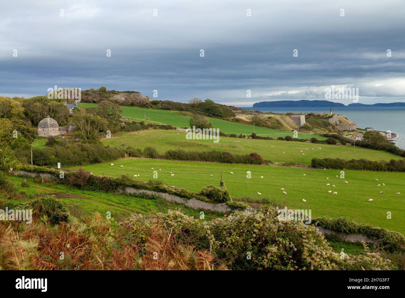 Penmon Point sull'isola di Anglesey con il Grande Orme in lontananza, Galles del Nord, Regno Unito Foto Stock