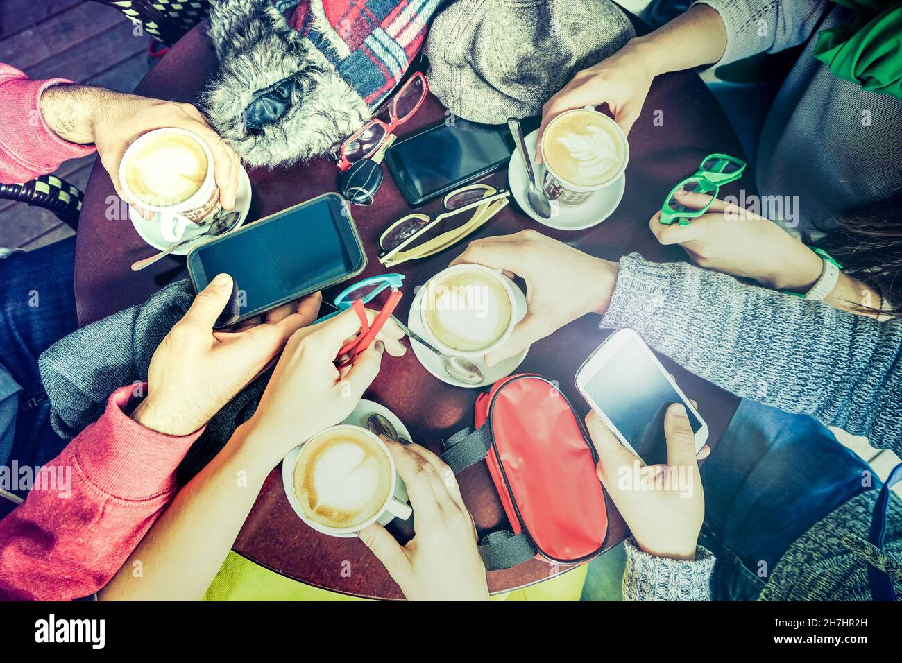 Gruppo di amici che bevono cappuccino al ristorante bar caffè - persone che usano lo smartphone dal punto di vista superiore - concetto di tecnologia Foto Stock