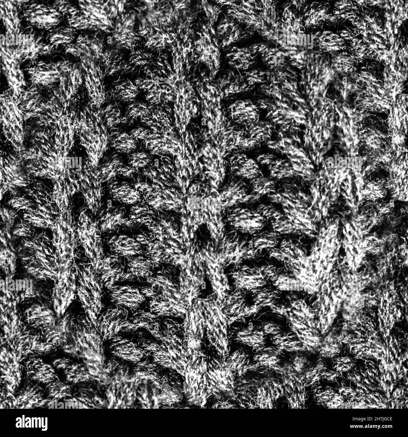 Lavorazione a maglia grigia senza cuciture. Sfondo natalizio fatto a mano. Foto Stock