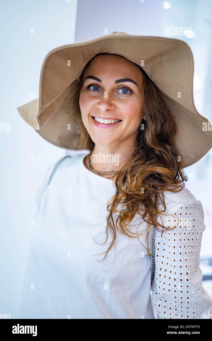 Closeup overjoyed giovane bruna femmina shopaholic vestendo cappello di moda che ha un'emozione positiva Foto Stock