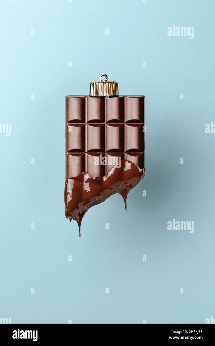 decorazioni natalizie in baule di cioccolato su sfondo blu. Concetto di Capodanno minimalista. Primo piano Foto Stock