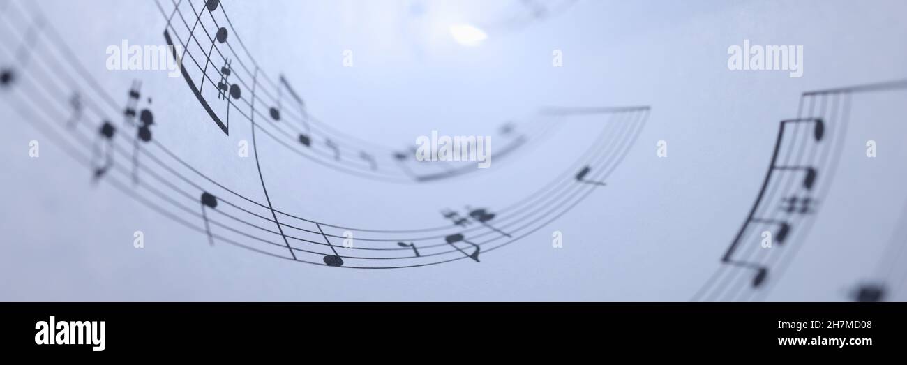 White paper con note musicali rotolato su primo piano sfondo Foto Stock