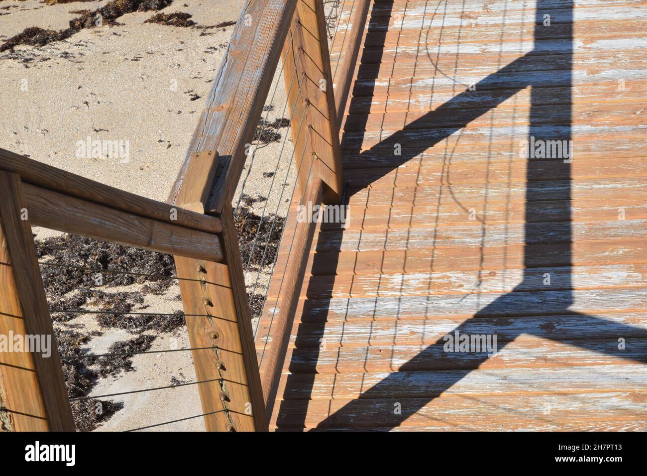 Cavi e ringhiere formano ombre sul legno. Foto Stock