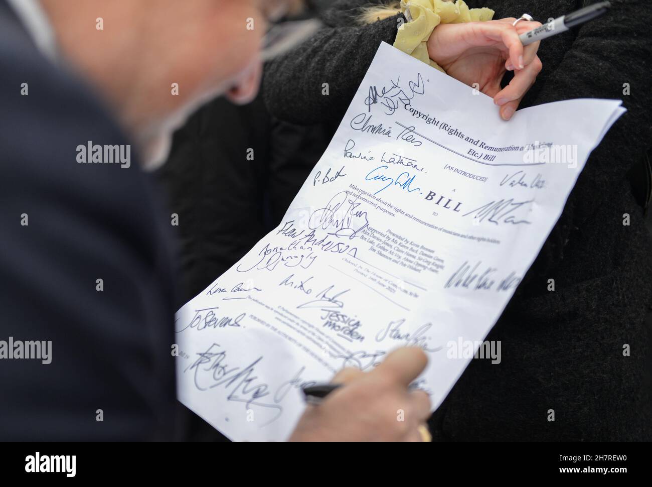 Londra, Regno Unito. 24 novembre 2021. Un artista ha firmato Bill durante la dimostrazione.musicisti, cantautori, artisti e produttori si sono Uniti insieme a Piazza del Parlamento per sostenere la nuova legge dell'MP Kevin Brennan per fissare lo streaming musicale. Questo nuovo disegno di legge porterà delle riforme per garantire che i musicisti siano pagati in modo adeguato per il loro lavoro. Credit: SOPA Images Limited/Alamy Live News Foto Stock