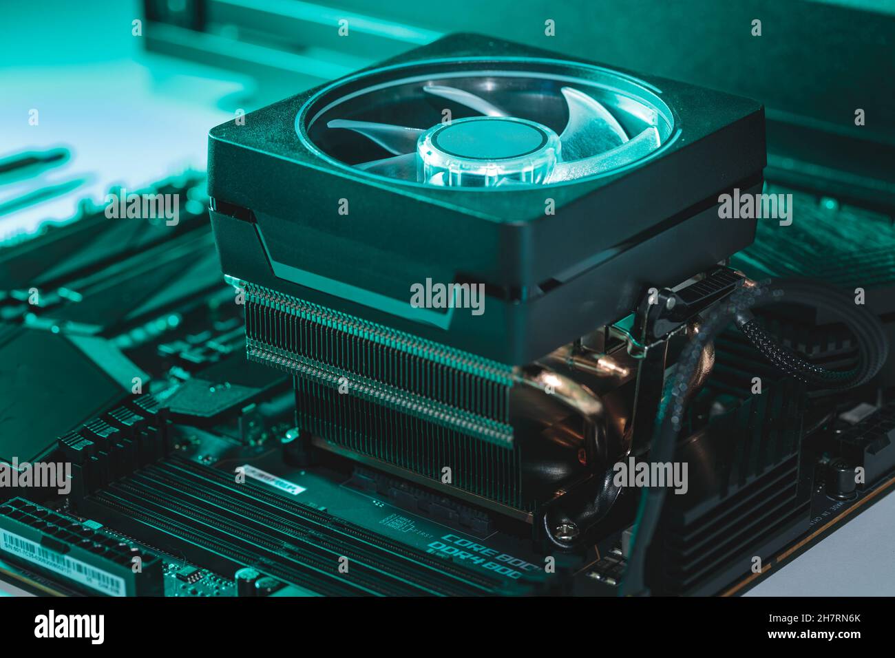 Refrigerante CPU su una scheda madre in luce teale Foto Stock