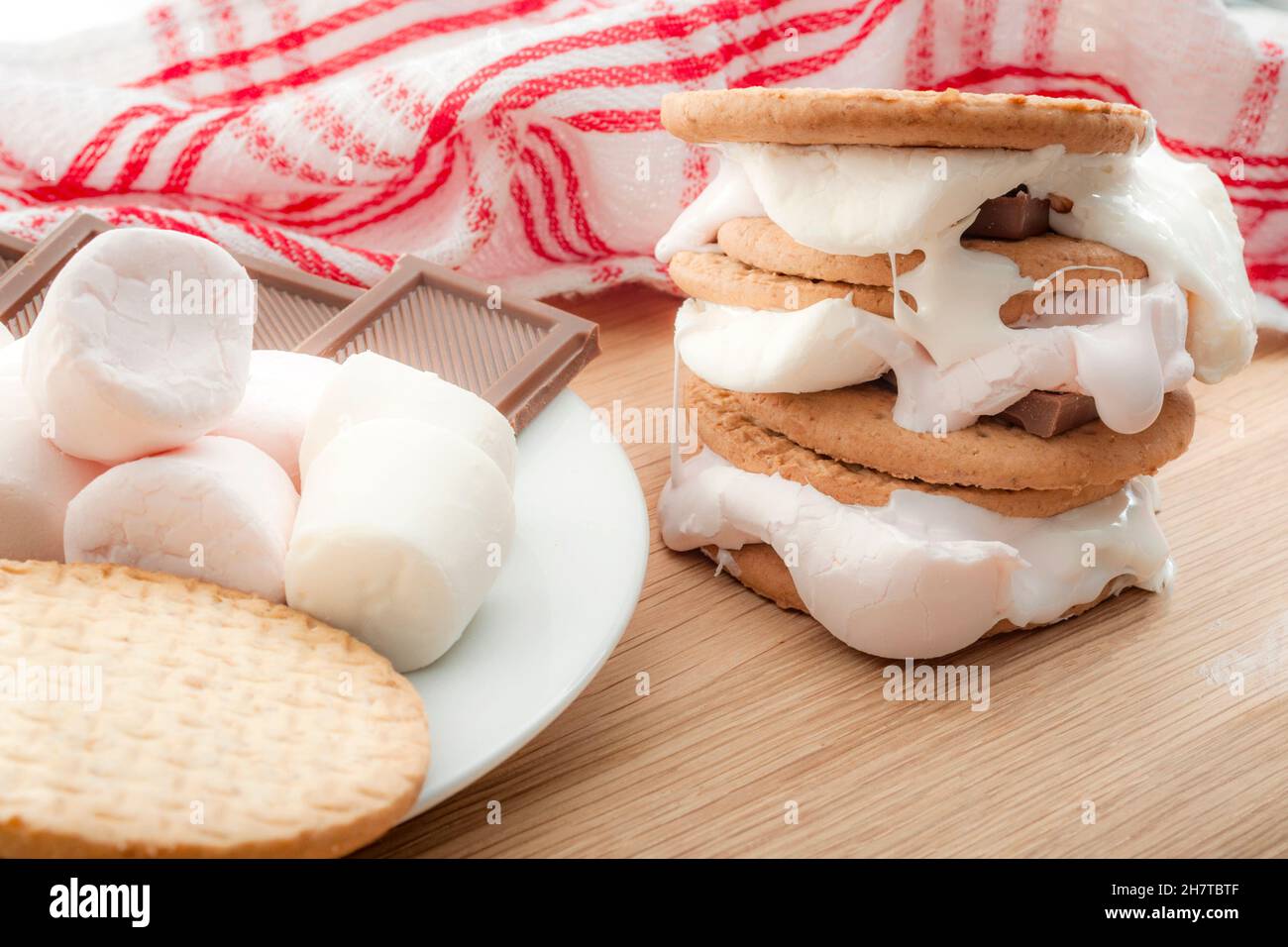 Dolci fatti in casa, smores e dessert dolce concetto con l'immagine rustica di s'mers accatastato accanto agli ingredienti cioccolato, cracker graham e marshmal Foto Stock