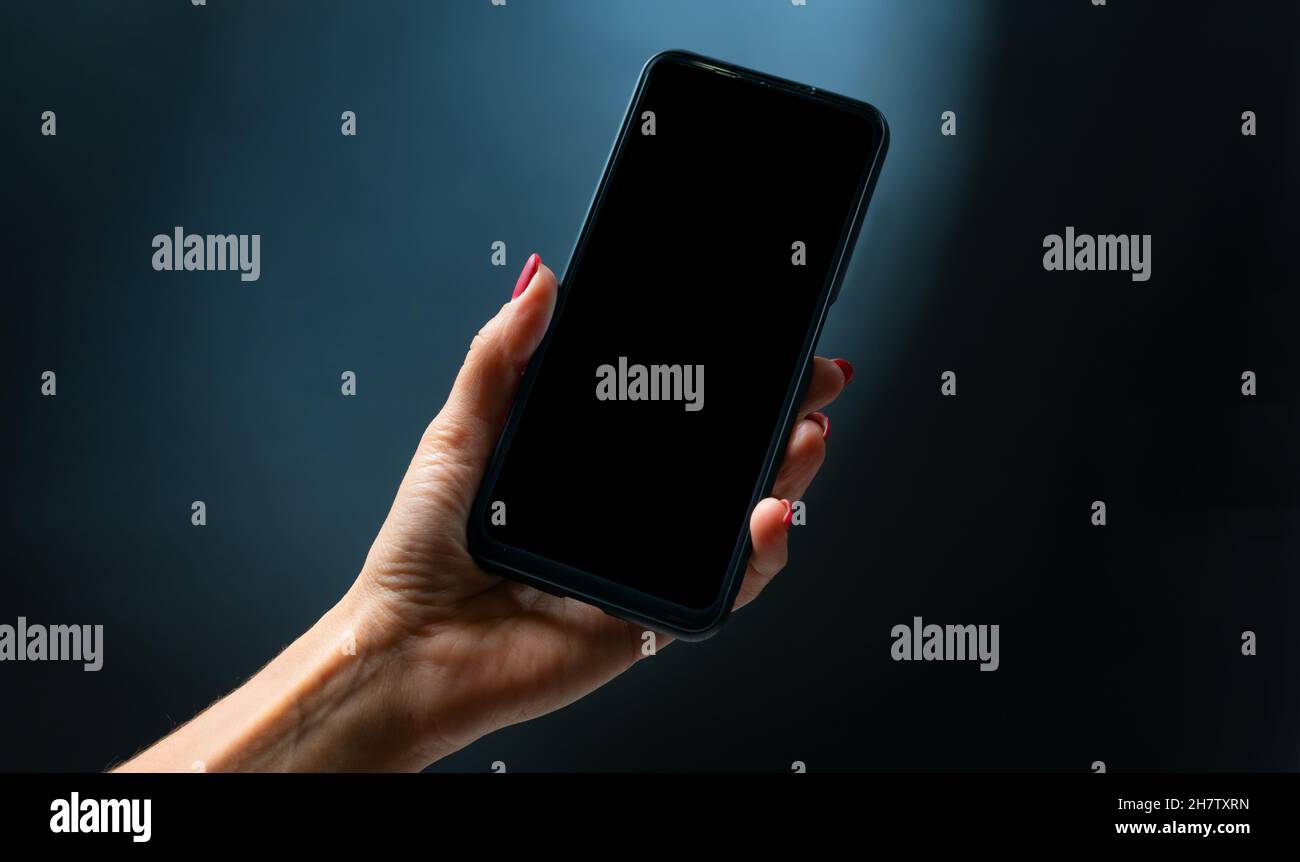 Mano azienda smartphone Foto Stock