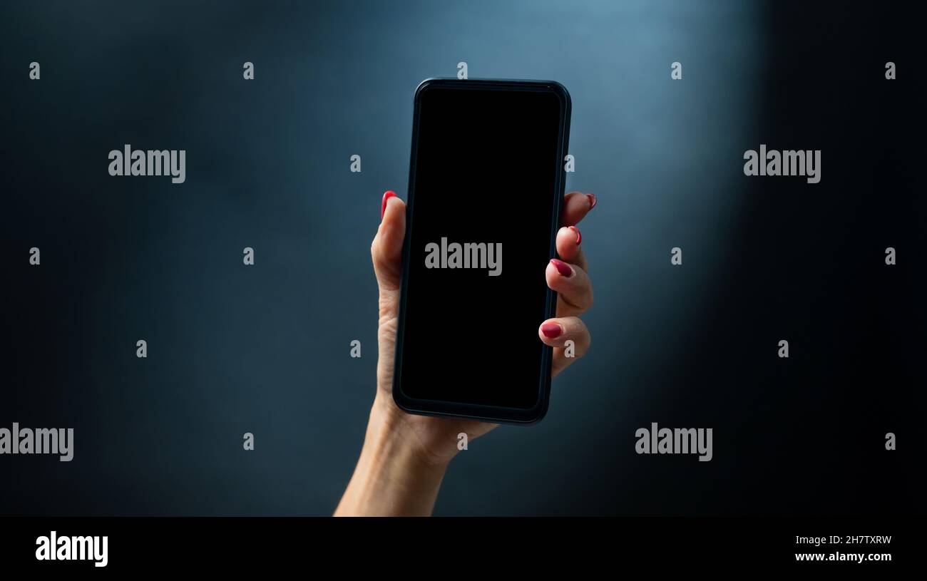Mano azienda smartphone Foto Stock