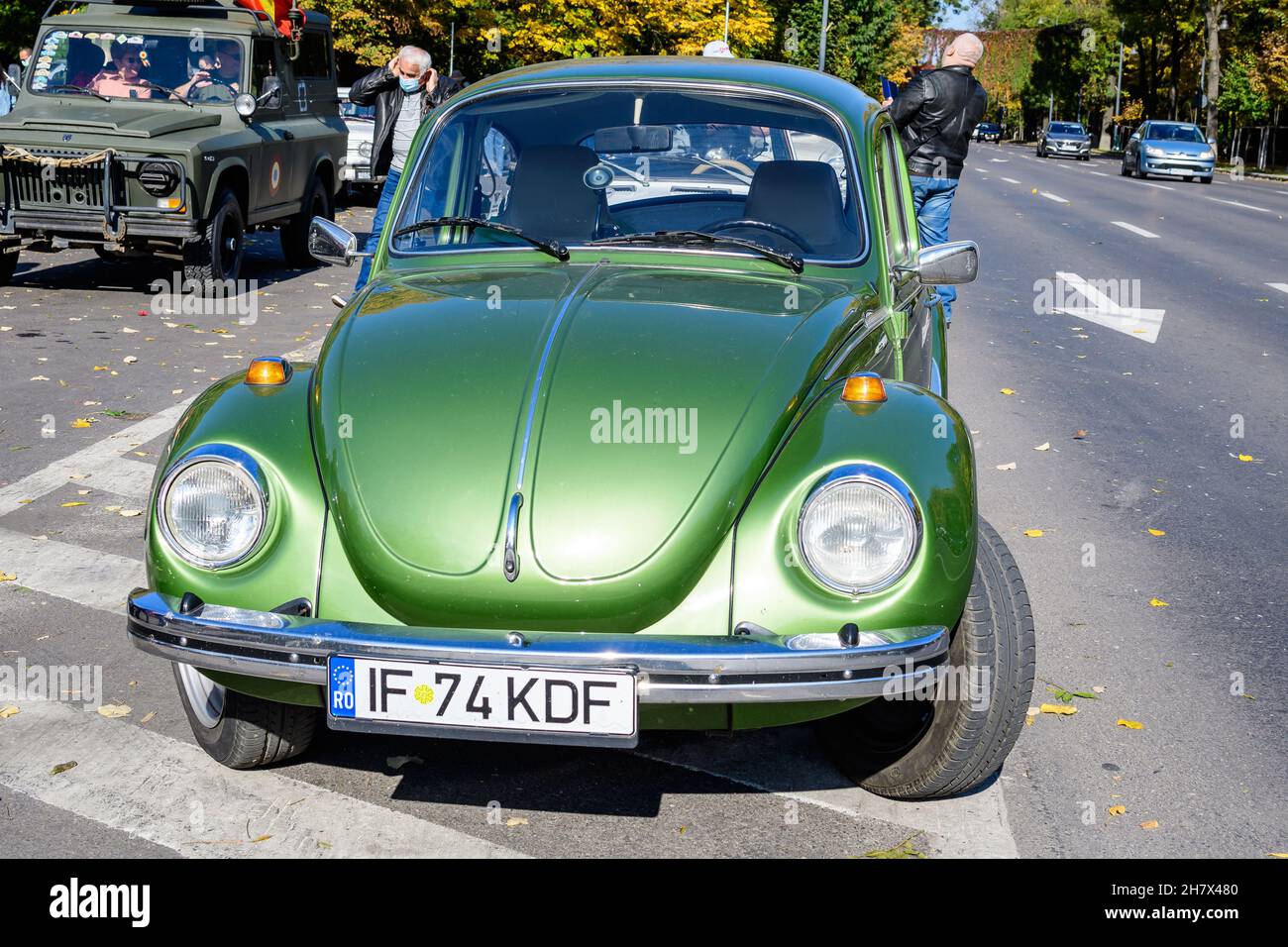 Bucarest, Romania, 24 ottobre 2021: Una VIVID Green Volkswagen Beetle auto d'epoca tedesca nel traffico in una strada in un evento per le auto d'epoca colletti Foto Stock