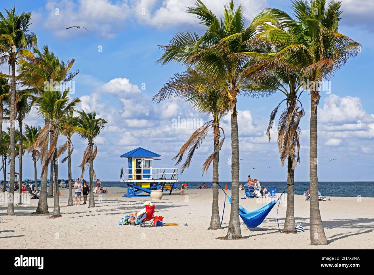Turisti e bagnino torre in inverno su Surfside Beach lungo l'Oceano Atlantico a Miami-Dade County, Florida, Stati Uniti / Stati Uniti d'America Foto Stock