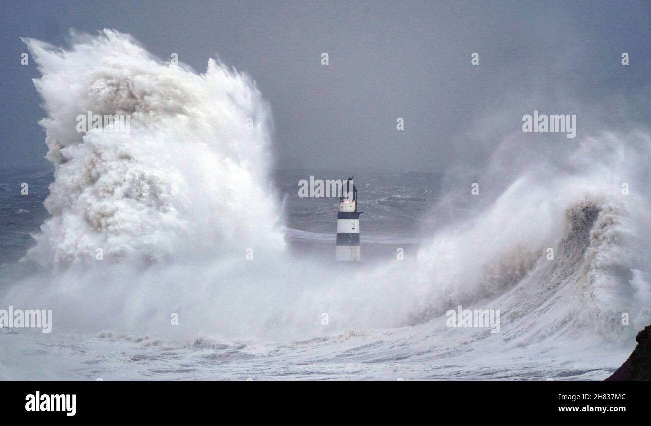 Enormi onde si scontrano contro il faro di Seaham Harbour, County Durham, alla fine della coda di Storm Arwen che ha visto raffiche di quasi 100 miglia all'ora in aree devastanti del Regno Unito. Data foto: Sabato 27 novembre 2021. Foto Stock