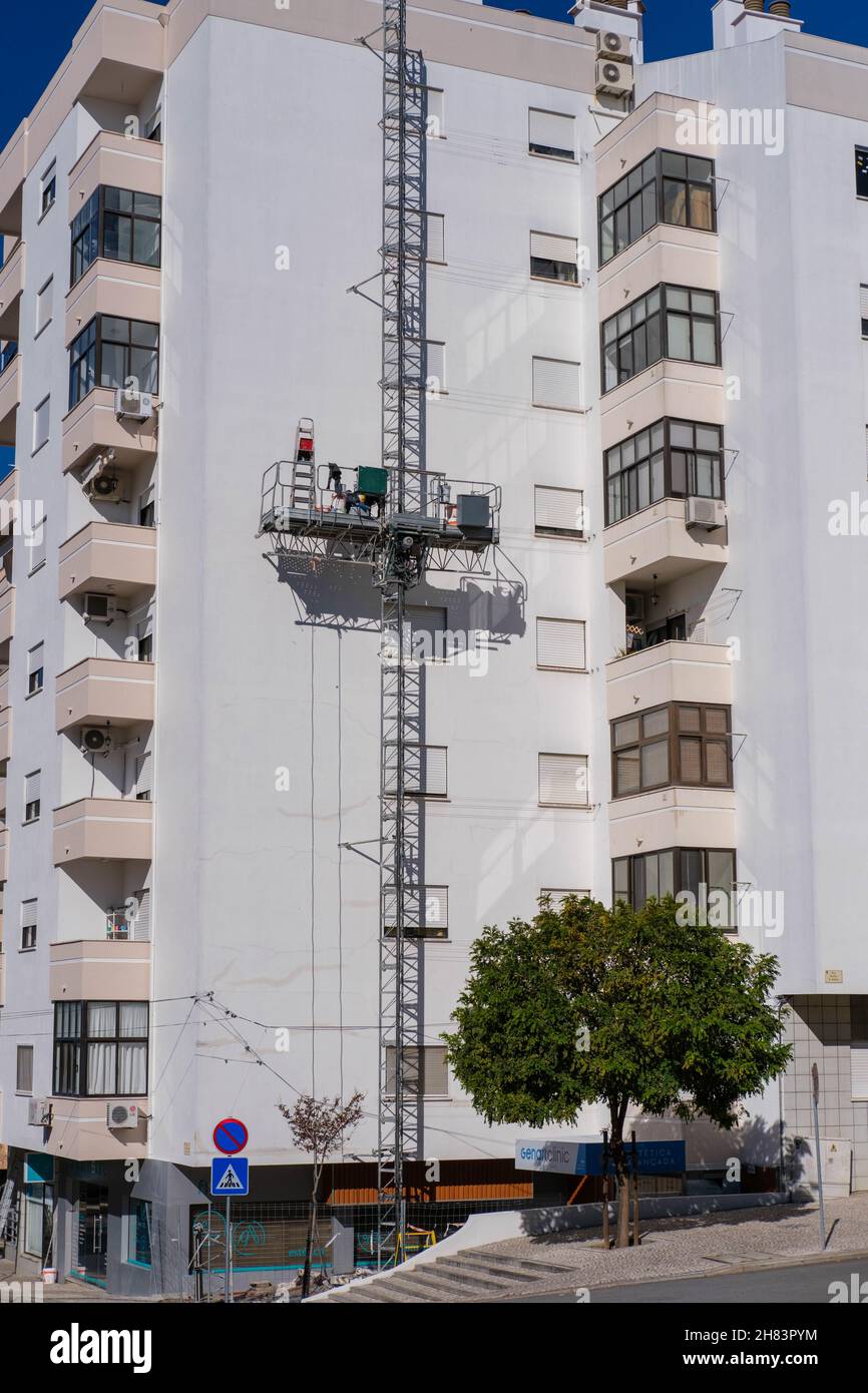 Castelo Branco, Portogallo - Novembre 09 2021: Maschera di arrampicata piattaforma di accesso aereo in uso su alta facciata edificio Foto Stock
