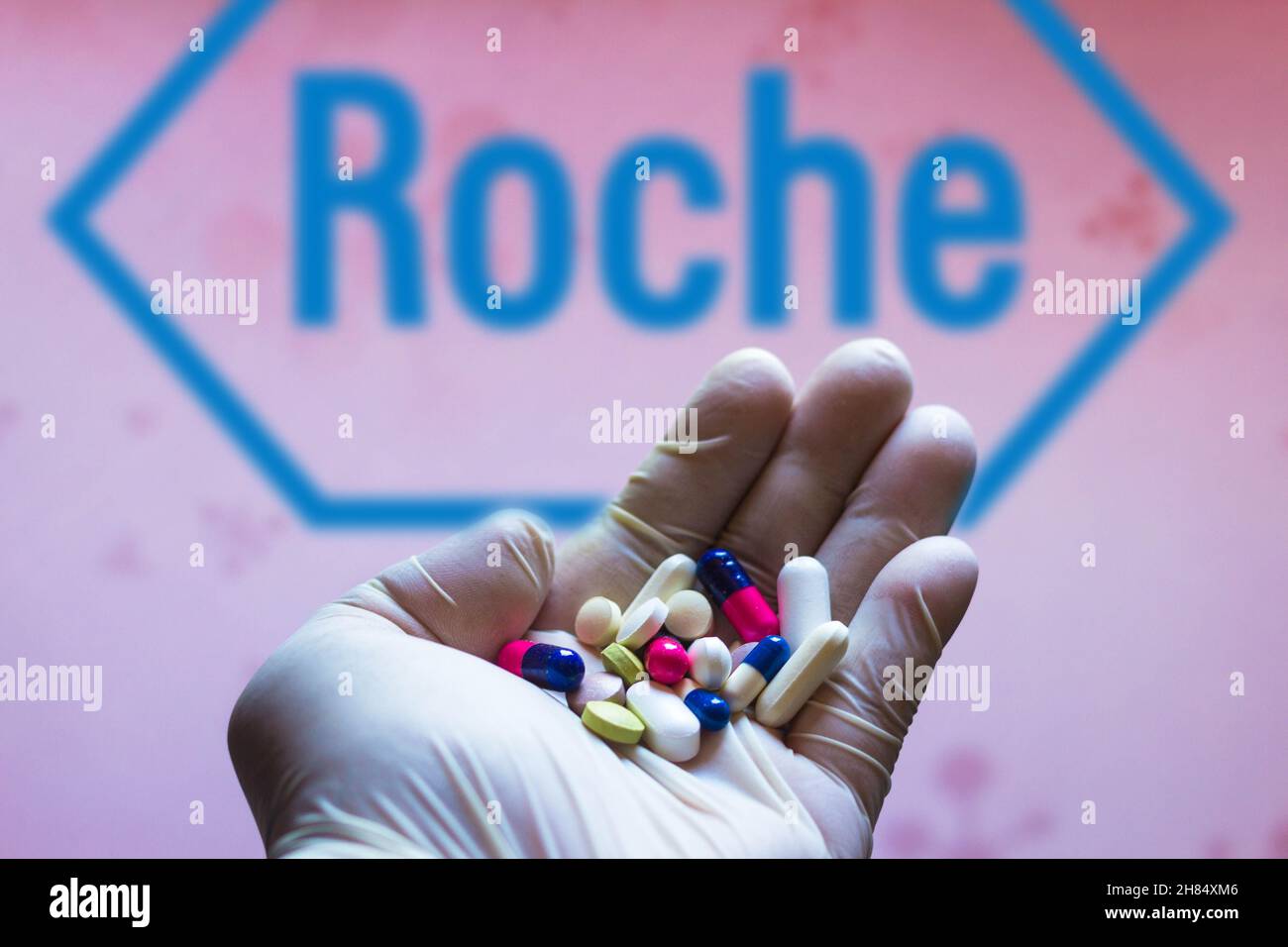 Brasile. 27 novembre 2021. In questa illustrazione della foto, un logo F. Hoffmann-la Roche AG è visto su uno schermo e una mano che tiene pillole. Credit: SOPA Images Limited/Alamy Live News Foto Stock