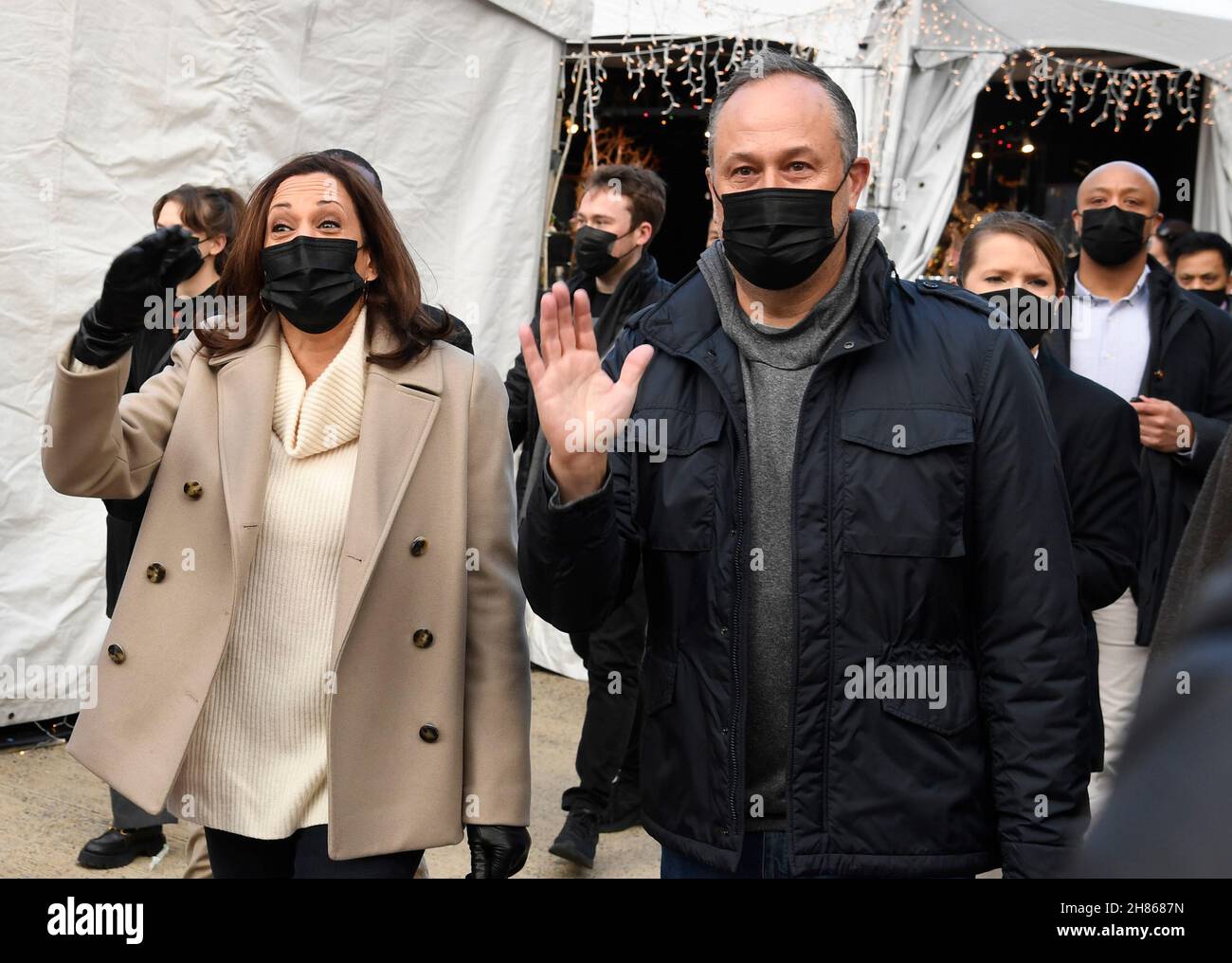 Washington, DC. 27 novembre 2021. Il vicepresidente degli Stati Uniti Kamala Harris (L) e il secondo gentleman Douglas Emhoff fanno l'onda agli acquirenti come sostengono le piccole imprese Sabato con una visita a DCs Downtown Holiday Market, Sabato, 27 novembre 2021, a Washington, CC. Credit: Mike Theiler/Pool via CNP/dpa/Alamy Live News Foto Stock