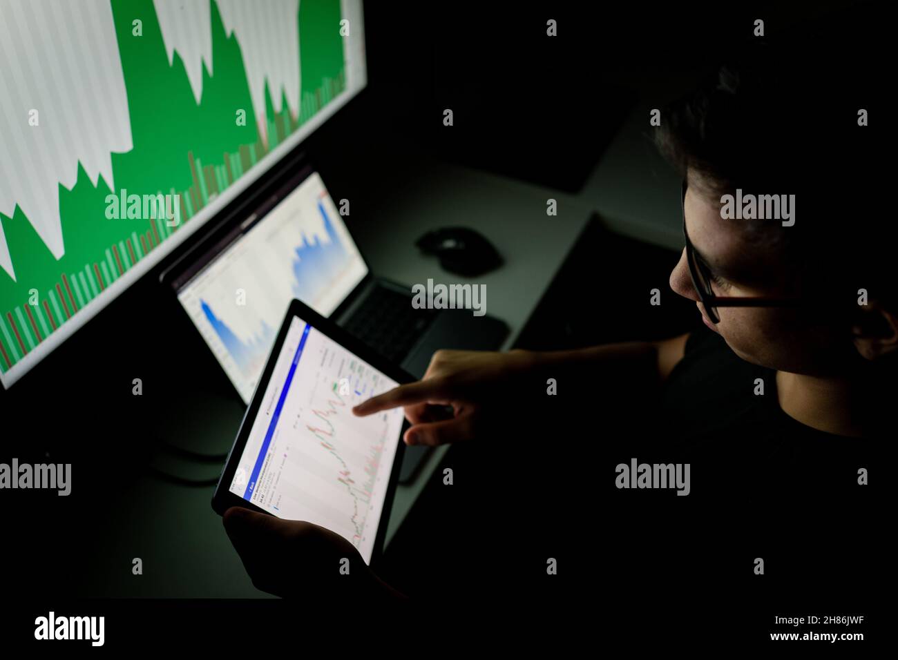 Crypto trader Investor Analyst guardando lo schermo che analizza i dati del grafico finanziario sul monitor del pc, pensando agli investimenti in borsa online . Foto Stock