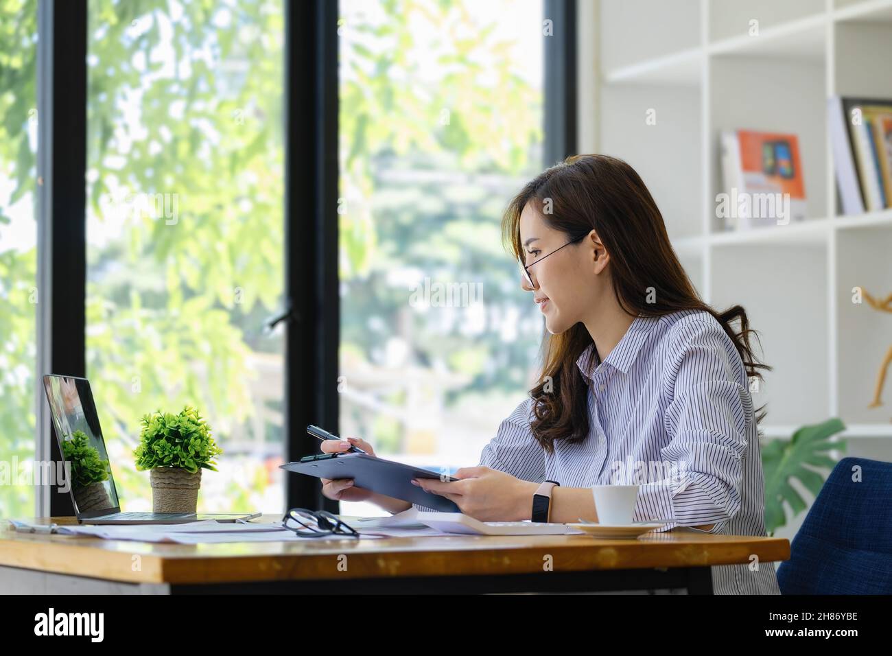 Lavoro da casa. Avviare un proprietario di piccola impresa utilizzando penne e documenti, il reddito aziendale personale e computer per lavorare. Foto Stock