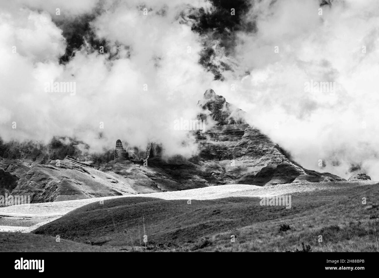 Le fitte nuvole si radunano intorno alle frastagliate cime di basalto dei Monti Drakensberg del Sud Africa. Queste montagne si sono formate a causa di un grande basalto alluvione Foto Stock
