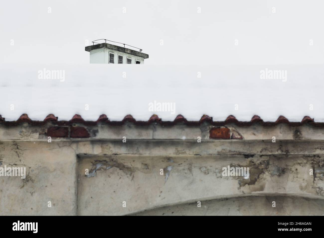 Lublino, Polonia - 13 febbraio 2021: Muro e camino coperto di neve pesante in inverno Foto Stock