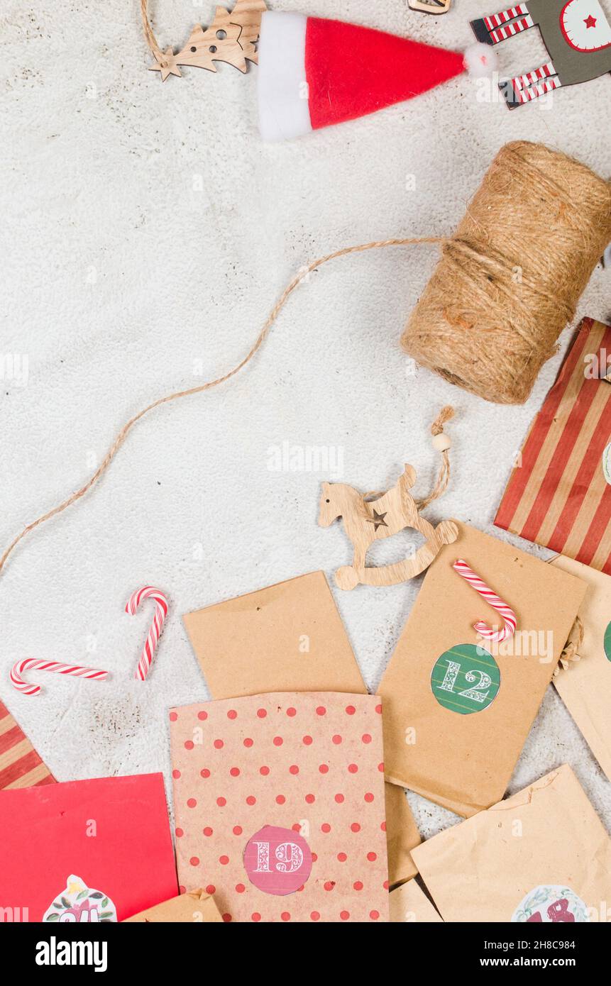 Casalingo originale Natale Avvento Calendario di borse di carta artigianale su sfondo scuro. In attesa di Natale con regali e dolci sorprese. Stagionale ca Foto Stock