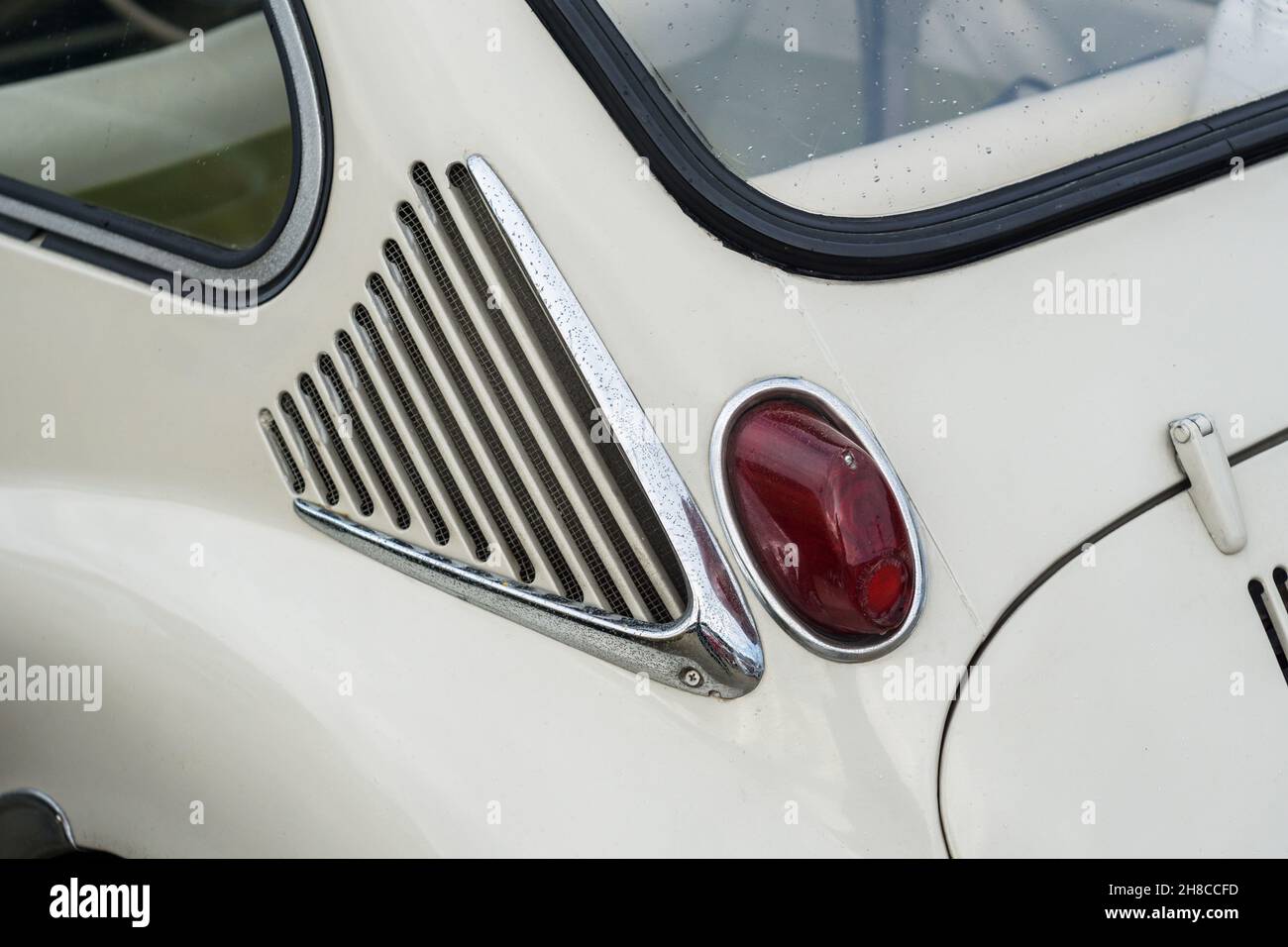 Primo piano dettaglio della luce di ventilazione e di stop su una classica city car giapponese Subaru 360 Deluxe di colore bianco Foto Stock