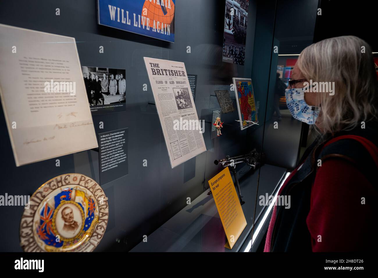 Imperial War Museum Lambeth London UK England November 2021 Model released woman views WW2 aniti semetic Newspaper The Britisher in the new WW2 Galler Foto Stock