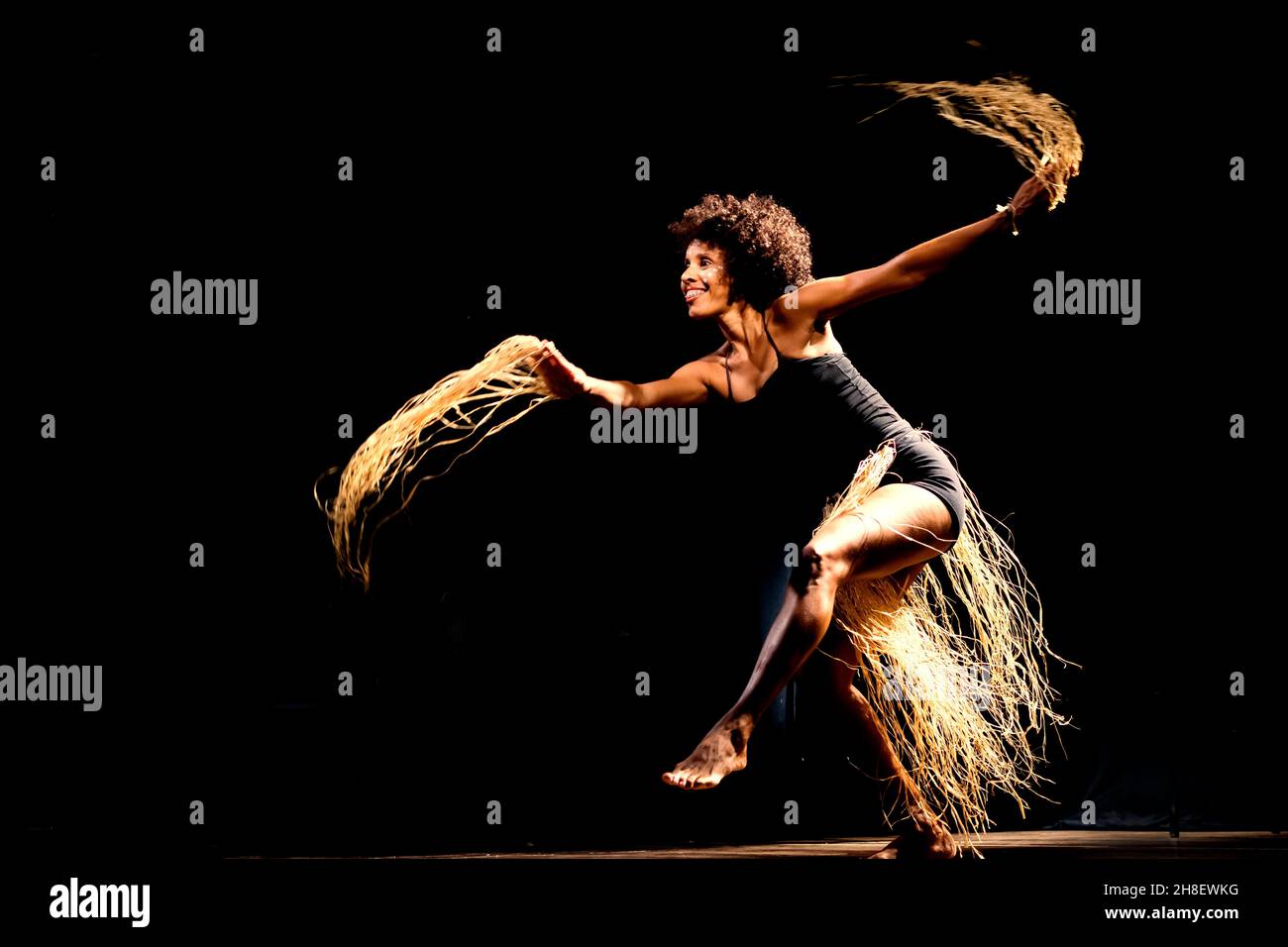 Ritratto di una donna che balla sul palco su sfondo nero. Salvador, Bahia, Brasile. Foto Stock