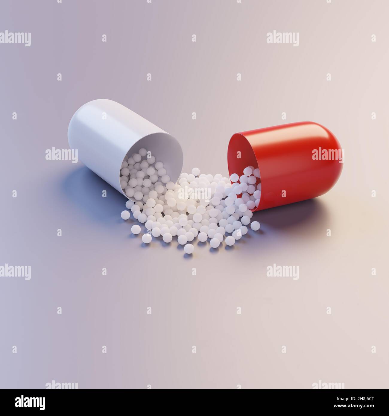 Una capsula di pillola aperta che spillano il principio attivo Foto Stock