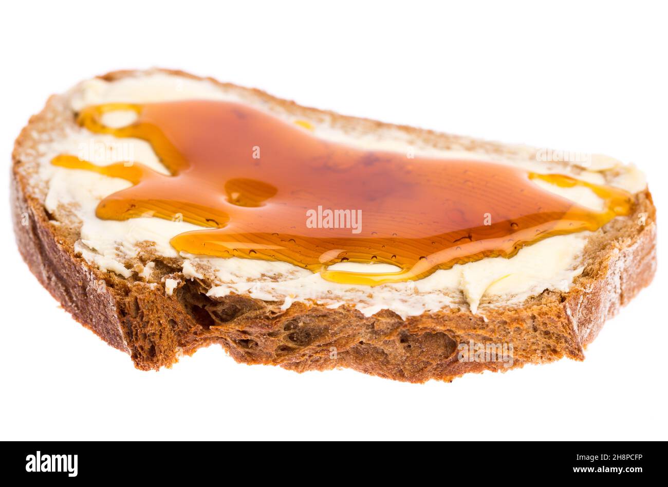 Un pane di miele isolato su sfondo bianco pane e miele, miele, pane, pane marrone, goccia, burro, eseguire Foto Stock