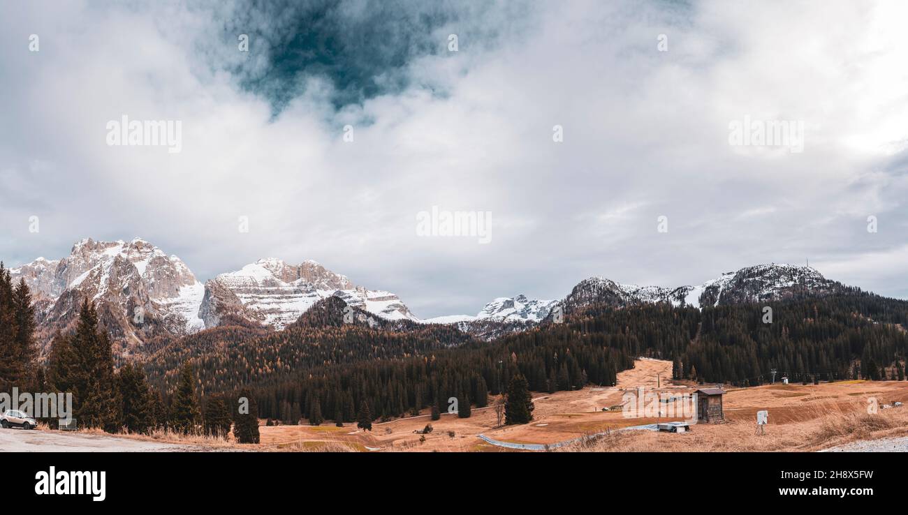 Vista panoramica del sole sulle cime innevate dell'Italia Alpi in autunno Foto Stock