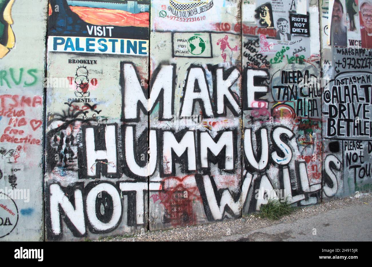 Graffiti di fare Hummus non muri sul muro di separazione a Betlemme Foto Stock