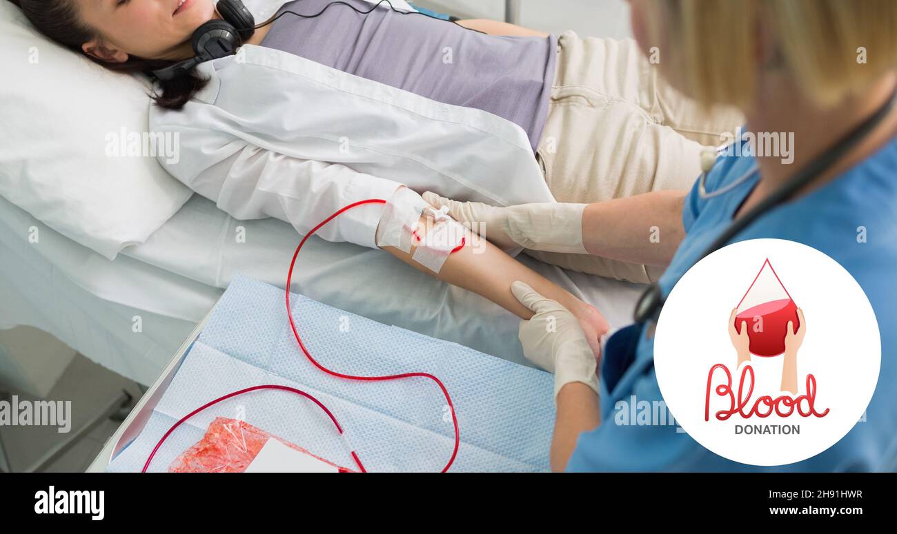 Medico che controlla la donna donando sangue sdraiato a letto in ospedale con il simbolo Foto Stock