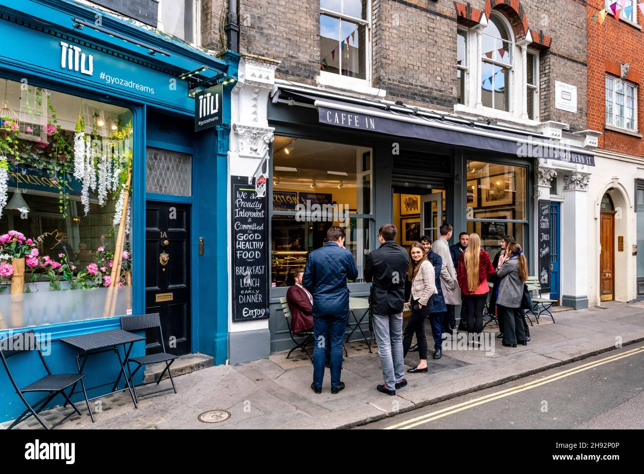 Un gruppo di giovani che si eregge fuori dal caffe a Mayfair, Shepherd Market, Londra, Regno Unito. Foto Stock
