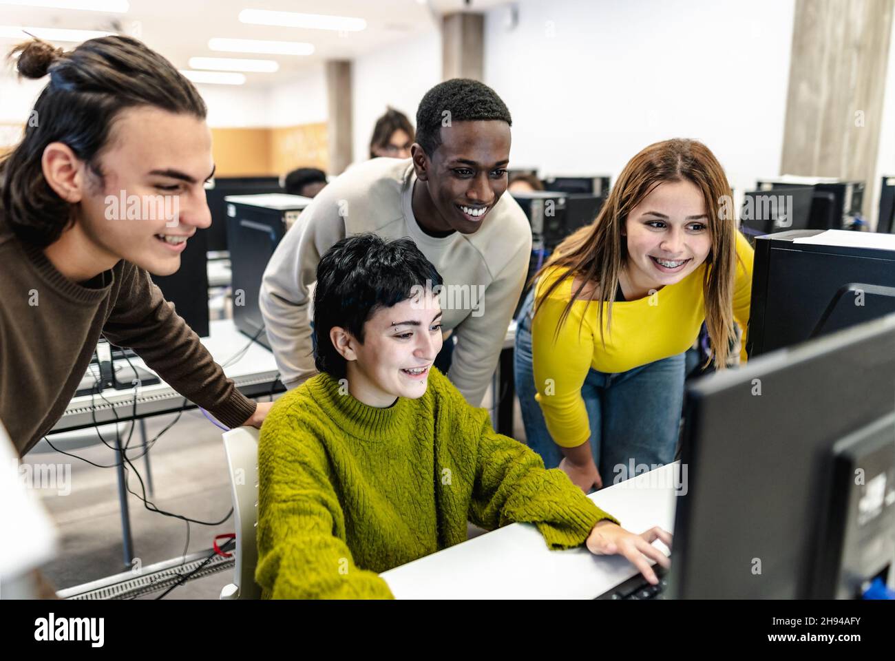 Giovani compagni di classe che studiano insieme all'interno dell'aula - concetto di istruzione Foto Stock