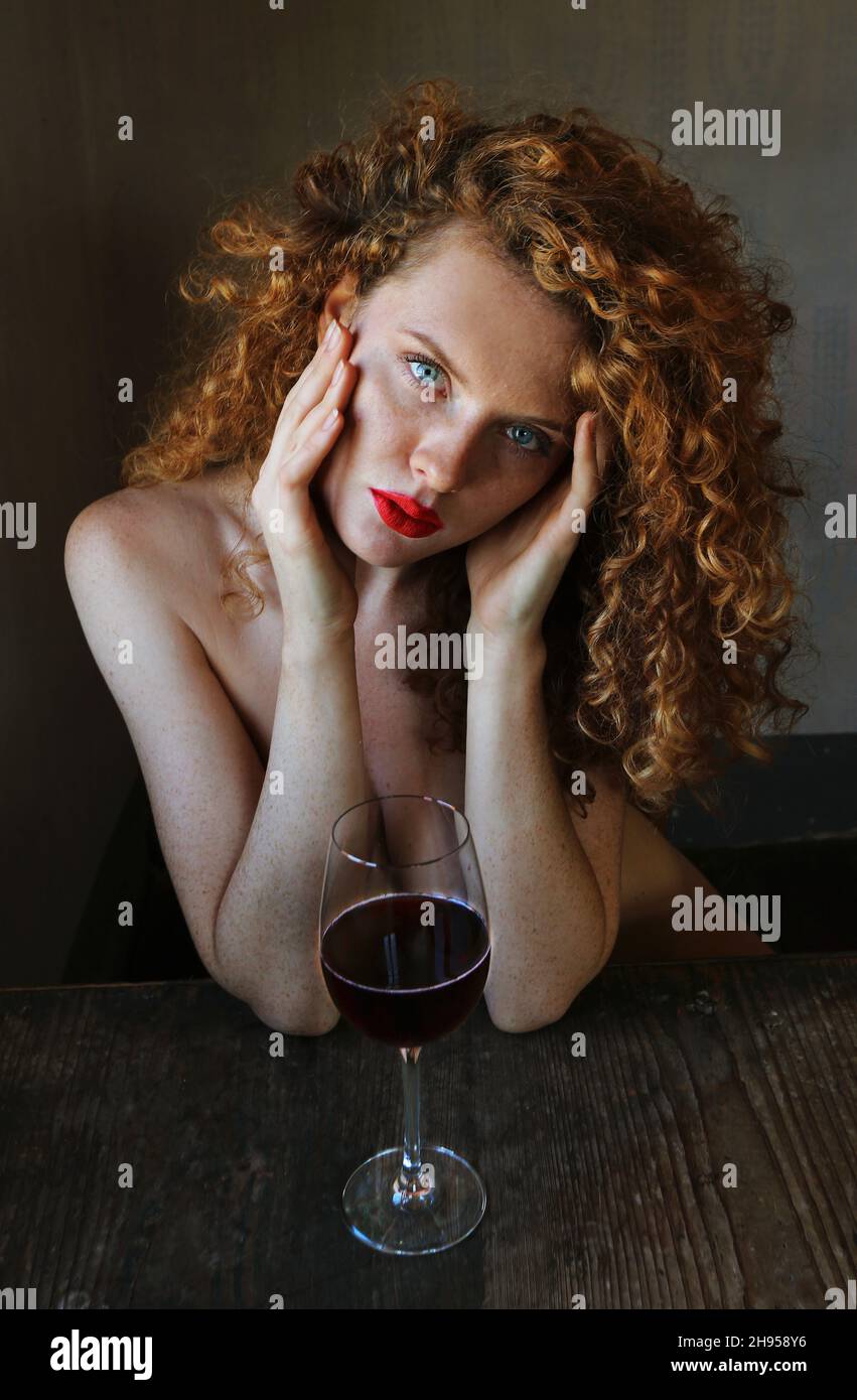 Ritratto Photographie einer schönen jungen Frau mit Roten Haaren, Sommersprossen, sinnlichen Blick, erotischen roten Lippen und blauen Augen Foto Stock