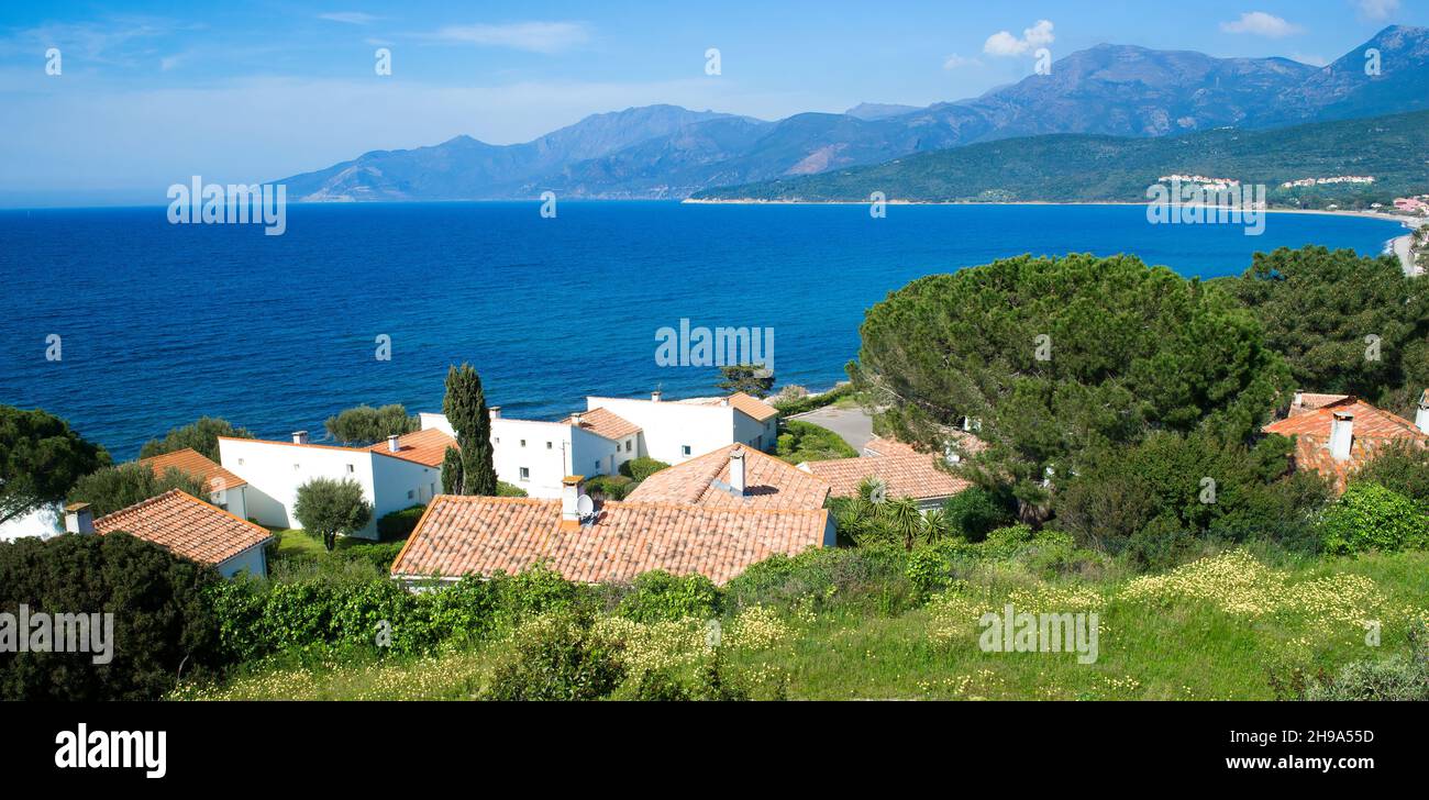 Baia di Saint Florent, mare Mediterraneo blu, colline e villaggio Foto Stock