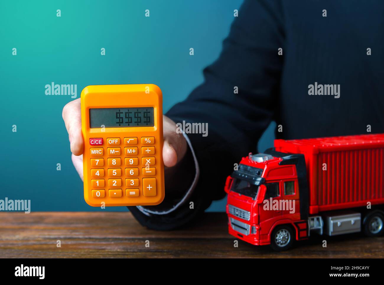 Businessman calcola il costo di spedizione di un container. Aumento dei prezzi, crisi della carenza di container globali. Importazione ed esportazione. Transito merci. Trasporto Foto Stock