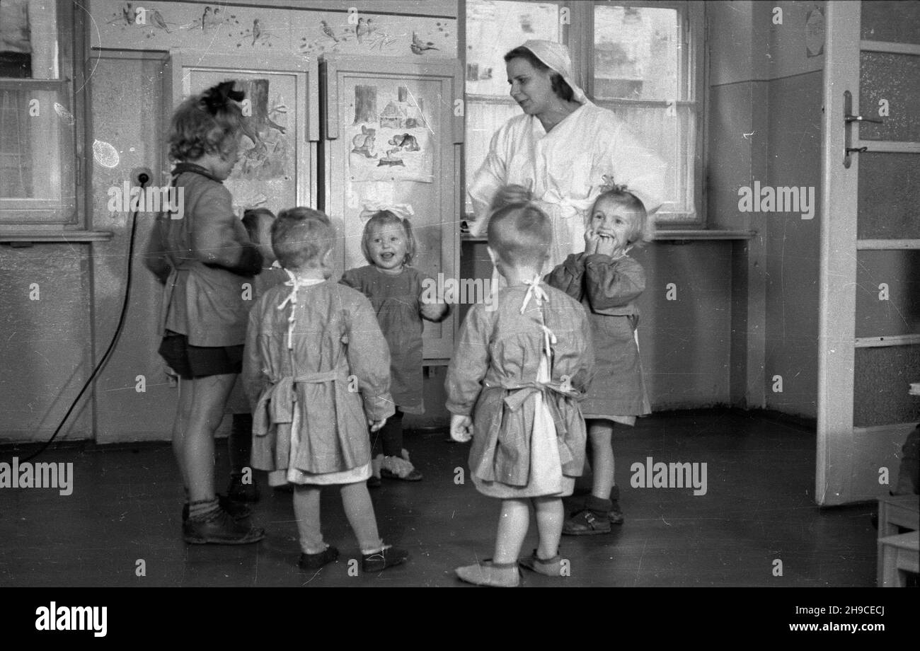 Warszawa, 1947-10. Przyzak³adowy ¿³obek w fabryce czekolady Franciszek Fuchs i Synowie przy ul. Topiel 12. NZ. Oppiekunka bawi siê z dzieæmi. mb/gr PAP Dok³adny dzieñ wydarzenia nieustalony. Varsavia, 1947 ottobre. Un'insenatura di lavoro presso la fabbrica di cioccolato Franciszek Fuchs e figli al 12 Topiel Street. Nella foto: Un chaperone che gioca con i bambini. mb/gr PAP Foto Stock