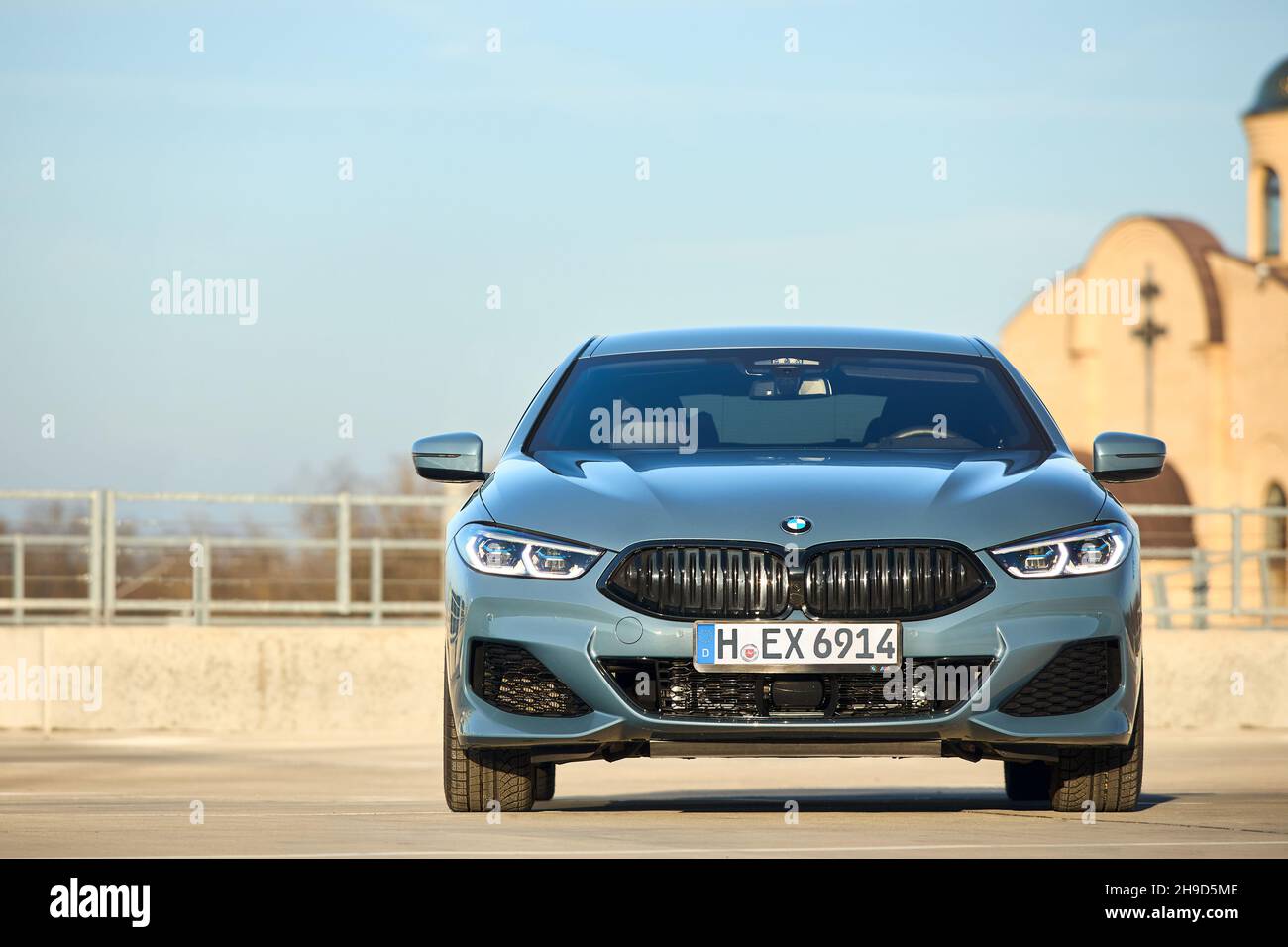 Berlino - Ottobre 2021: BMW Serie 8 Gran Coupé G16 840i xDrive M-pack 2021. Vista frontale fuoco selettivo su sfondo urbano con tempio sotto il blu Foto Stock