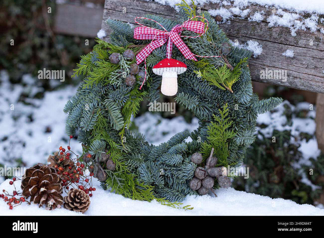 decorazione giardino d'inverno con corona d'avvento e fly agaric decorativo Foto Stock