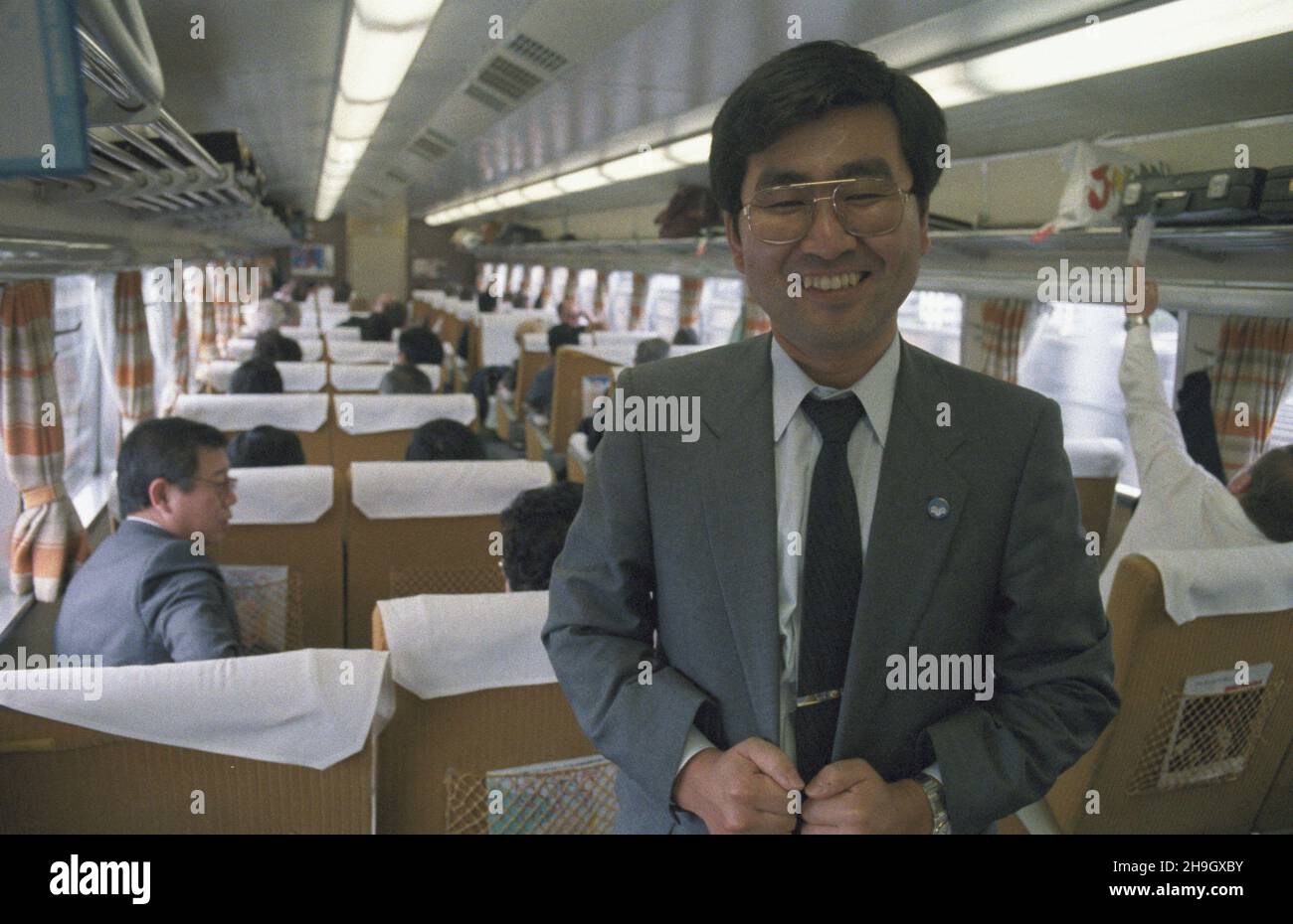 Japonia Tokio 01.07.1987. Wyjazd polskiej delegacji z Tokio do Kioto w trzecim dniu oficjalnej wizyty przewodnicz¹cego Rady Pañstwa Wojciecha Jaruzelskiego w Japonii. Podró¿ superszybkim poci¹giem Shinkansen NZ. cz³onek japoñskiego Ministerstwa Spraw Zagranicznych Takeuchi. uu PAP/Grzegorz Rogiñski Tokyo, 1 luglio 1987. Il Capo dello Stato polacco, il generale Wojciech Jaruzelski e la sua delegazione partono da Tokyo per Kyoto a bordo del treno ad alta velocità Shinkansen. Nella foto: Ufficiale del Ministero degli Esteri giapponese Takeuchi. uu PAP/ Grzegorz Roginski Foto Stock