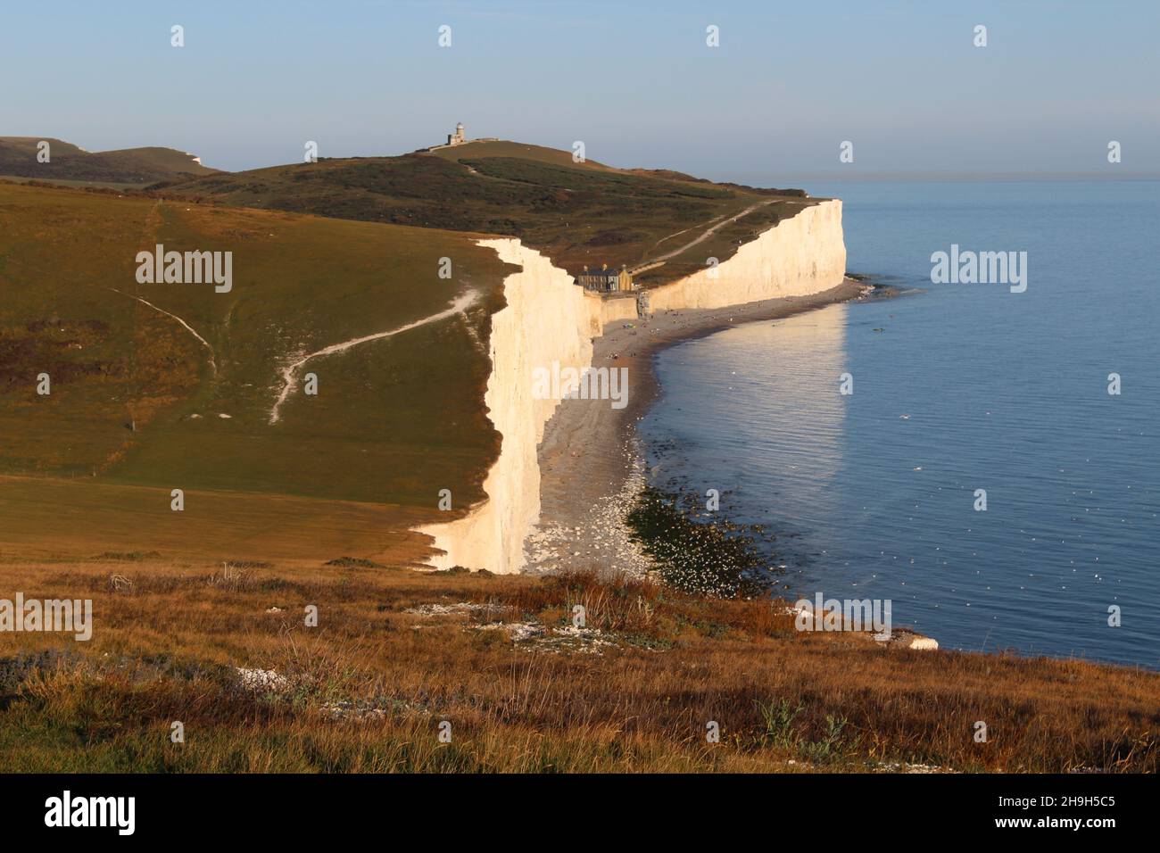 Sette Sorelle scogliere di gesso guardando verso Birling Gap al tramonto Foto Stock