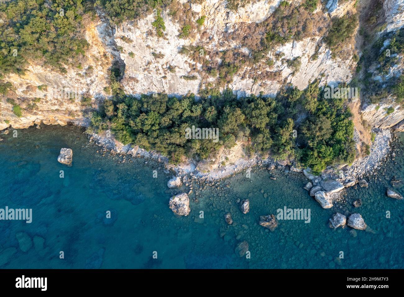 Drohnenaufnahme einer Steilküste a Griechenland. Baum, Klippe, Meer, Wasser, Grün, blau Foto Stock