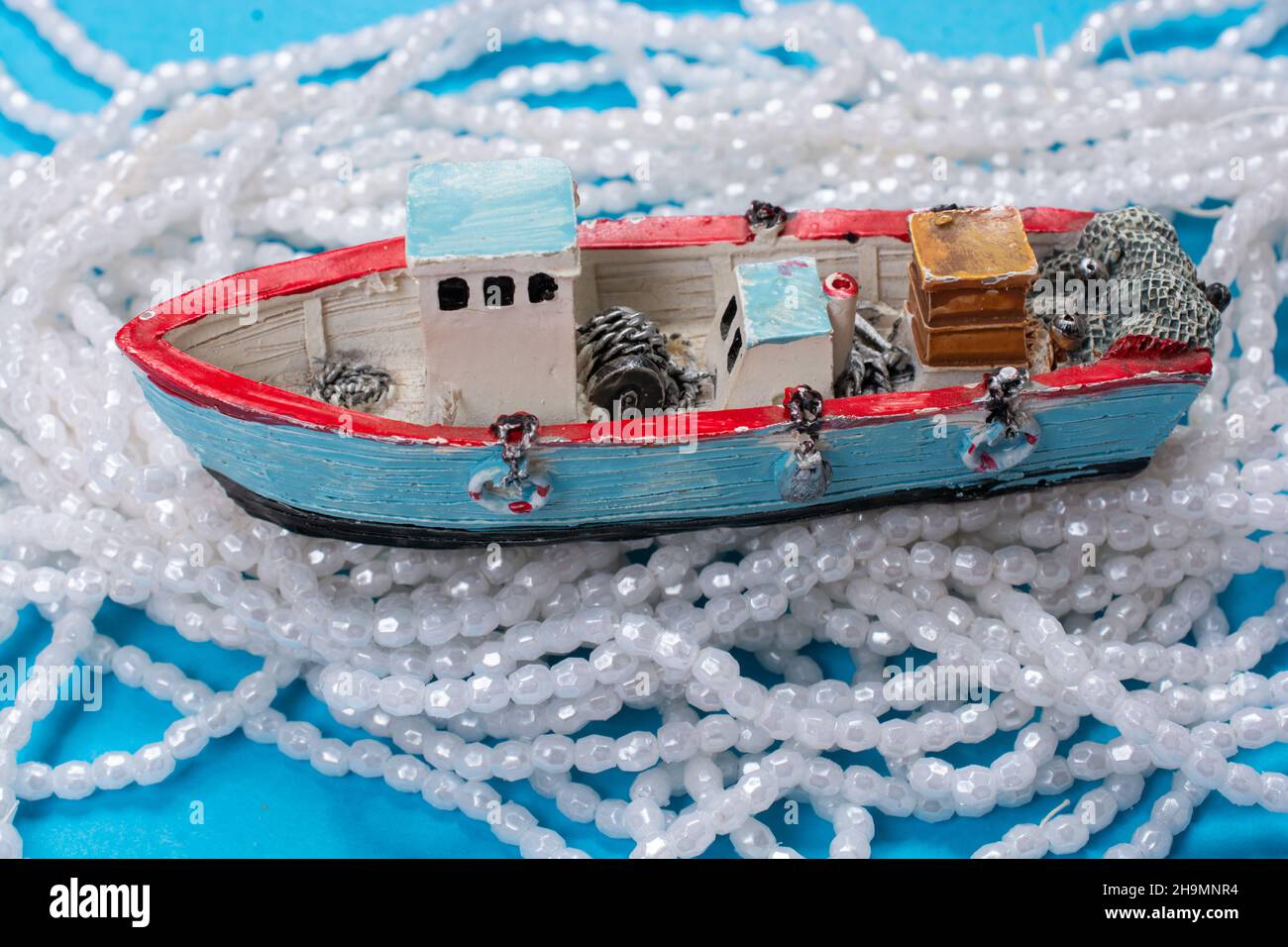 Modello di barca a vela vecchia posto su sfondo rosa. Scatto orizzontale Foto Stock