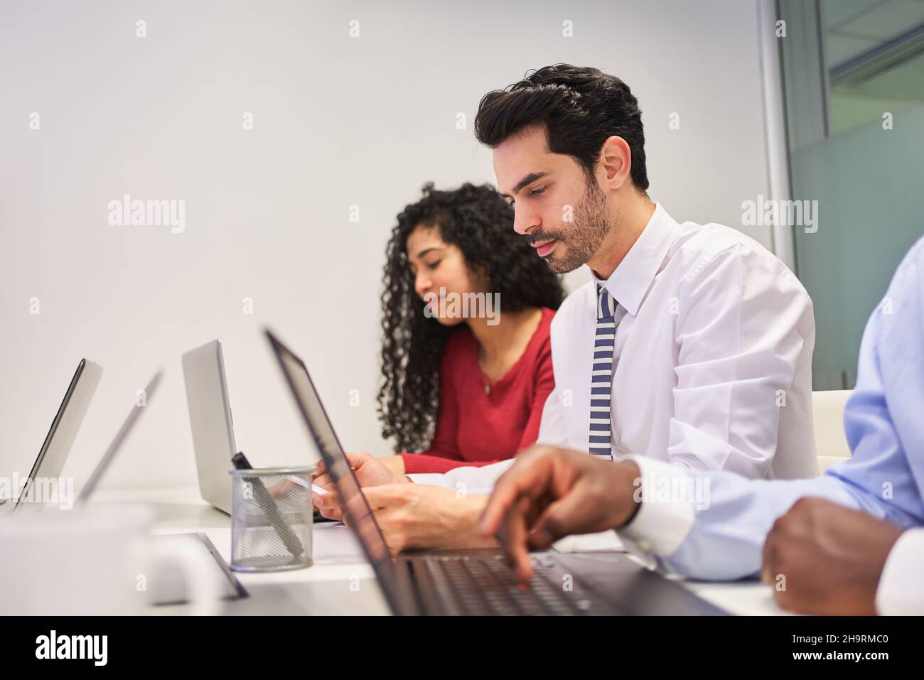 Giovani uomini d'affari in un corso di formazione in un laboratorio informatico o durante l'e-learning Foto Stock