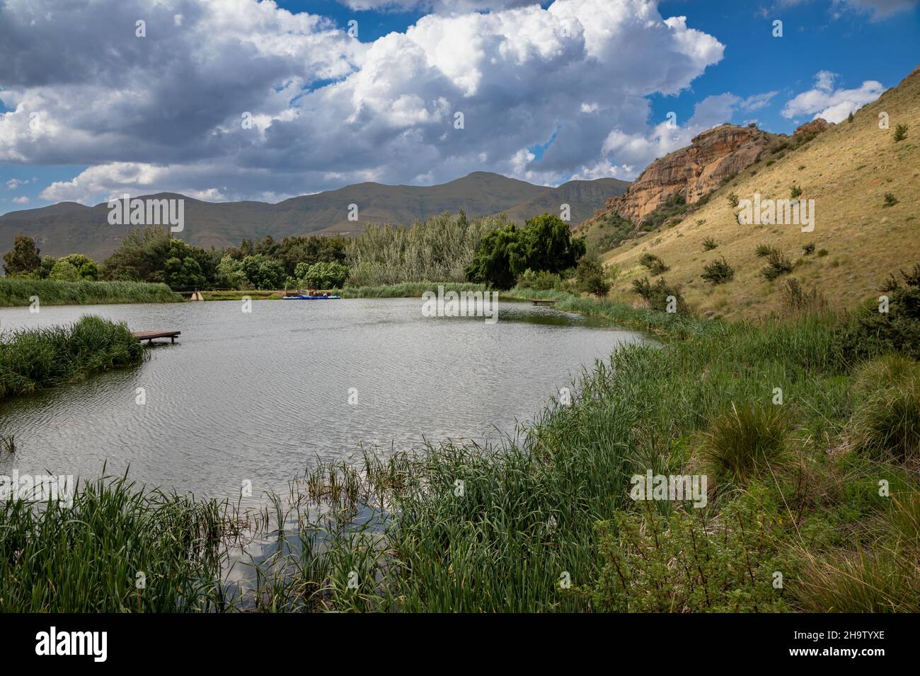 Paesaggio tranquillo scena di una diga circondata da montagne sullo sfondo Foto Stock