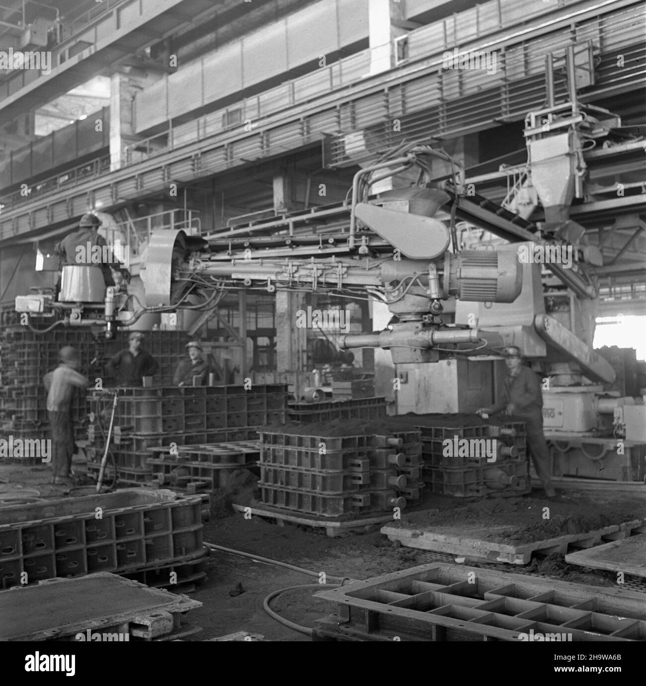 Œrem, 1969-12-04. Odlewniê ¿eliwa, uruchomion¹ w roku 1968, wybudowano di z³agodziæ deficyt odlewów dla przemys³u silników okrêtowych (przede wszystkim dla poznañskich zak³adów H. Cegielskiego), przemys³u obrabiarkowego i armatury przemys³owej oraz wyeliminowaæ import tych odlewów. Zak³ad produkuje odlewy z ¿eliw: Szarego, stopowego i sferoidalnego w RÓ¿nych klasach, w szerokim asortymencie wagowym (od 0,3 kg do 30 000 kg) w iloœci ok. 65 000 t rocznie. NZ. Zasypywanie form odlewniczych mas¹ formiersk¹ za pomoc¹ urz¹dzenia automatycznego, sterowanego jednoosobowo. mta PAP/Zbigniew Staszyszyn Foto Stock